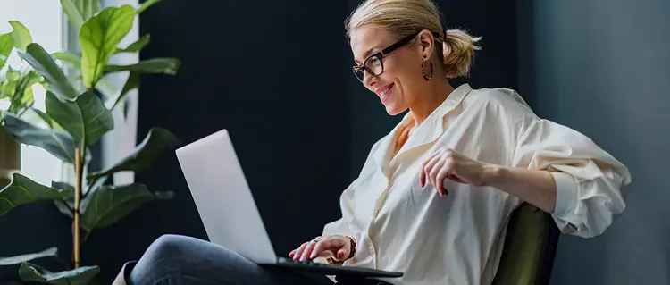 A person sitting in front of a laptop computer.