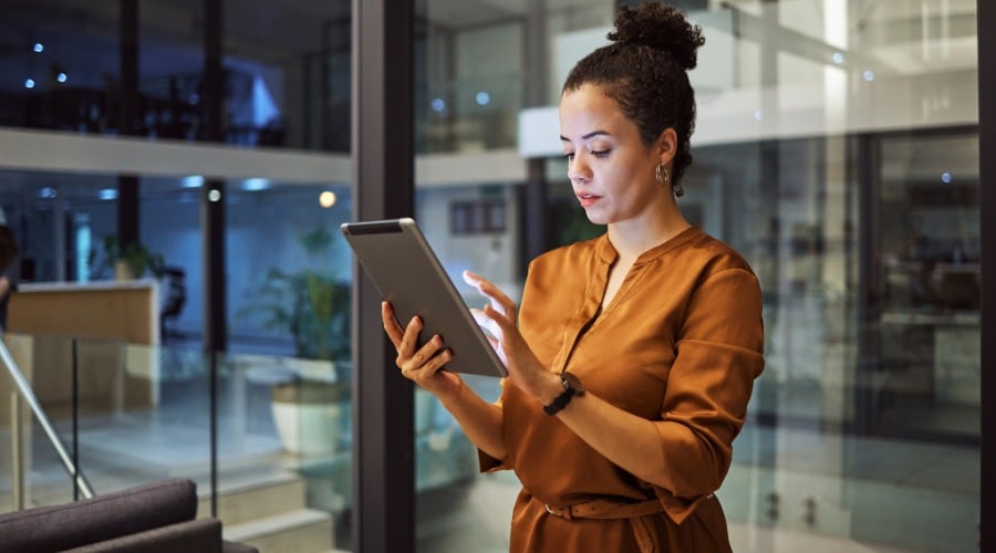 Woman Using Tablet in Modern Office Setting