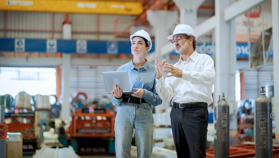 An image of two construction managers evaluating cash position reports.