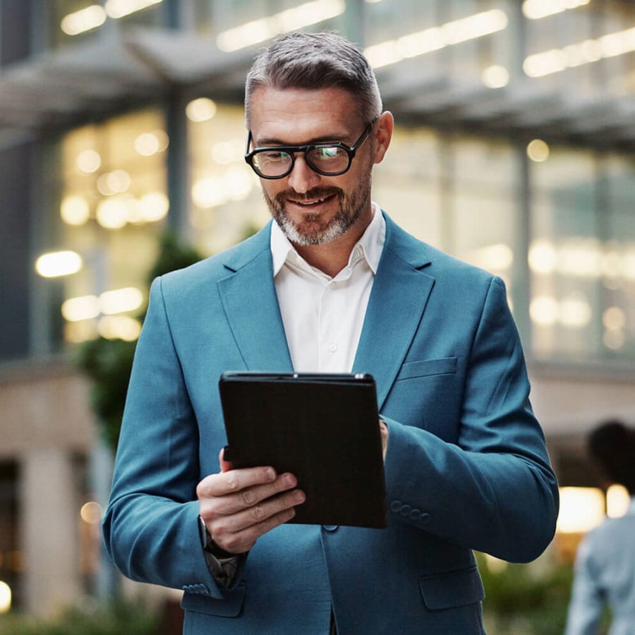 A person in a suit and tie holding a smart phone.