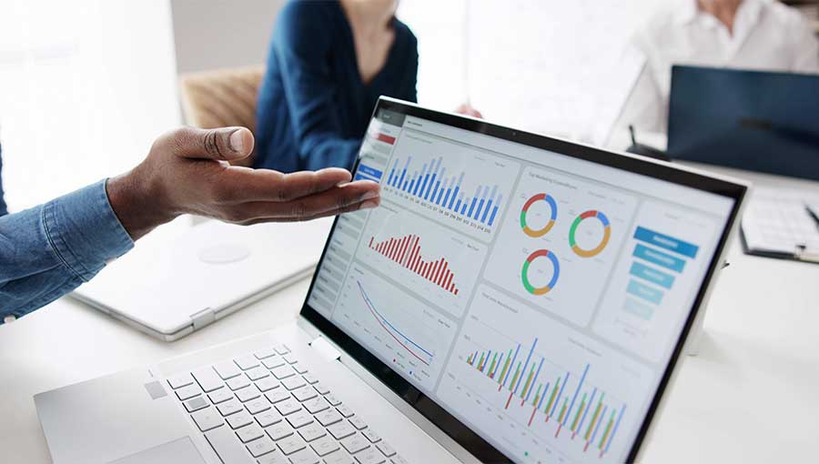 An image of a businessperson looking at a dashboard report as part of the data-driven decision-making process.