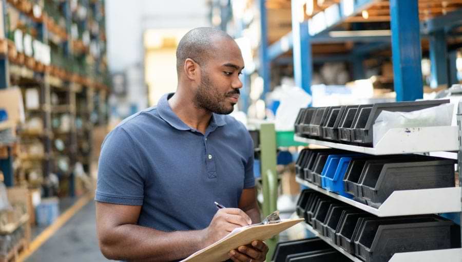 An image of a man in a warehouse doing MRO inventory management.