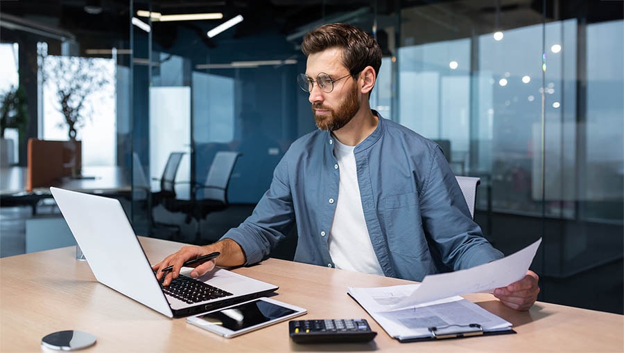 A business executive researching automatic payroll processing.