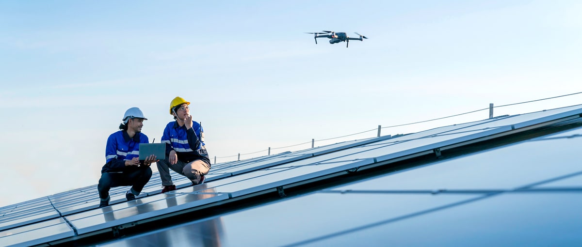 Two construction workers using a drone, one of the construction technology trends of 2026.